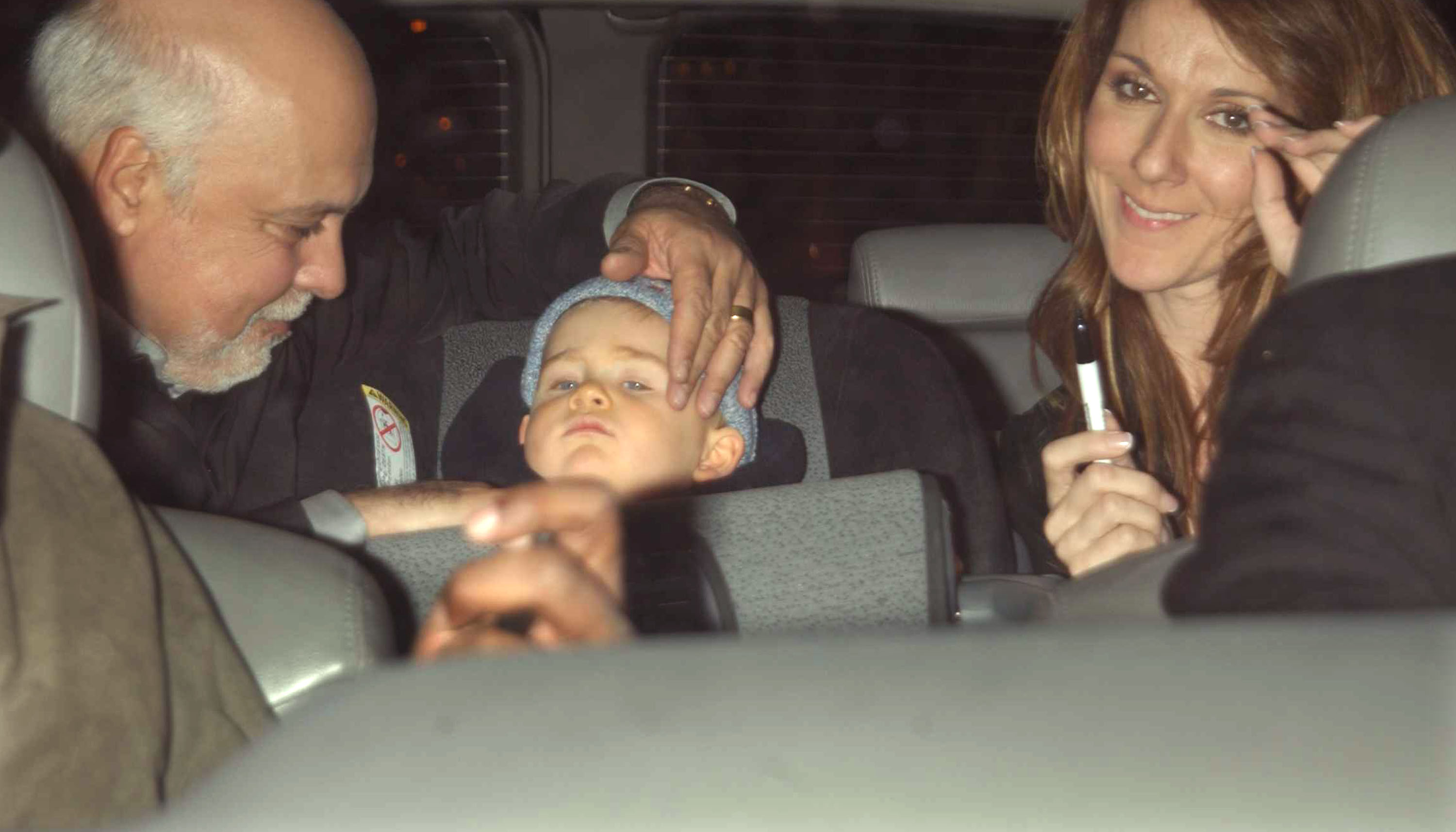 Rene Angelil, Rene-Charles and Celine Dion photographed inside a vehicle on March 27, 2002 in New York City. | Source: Getty Images