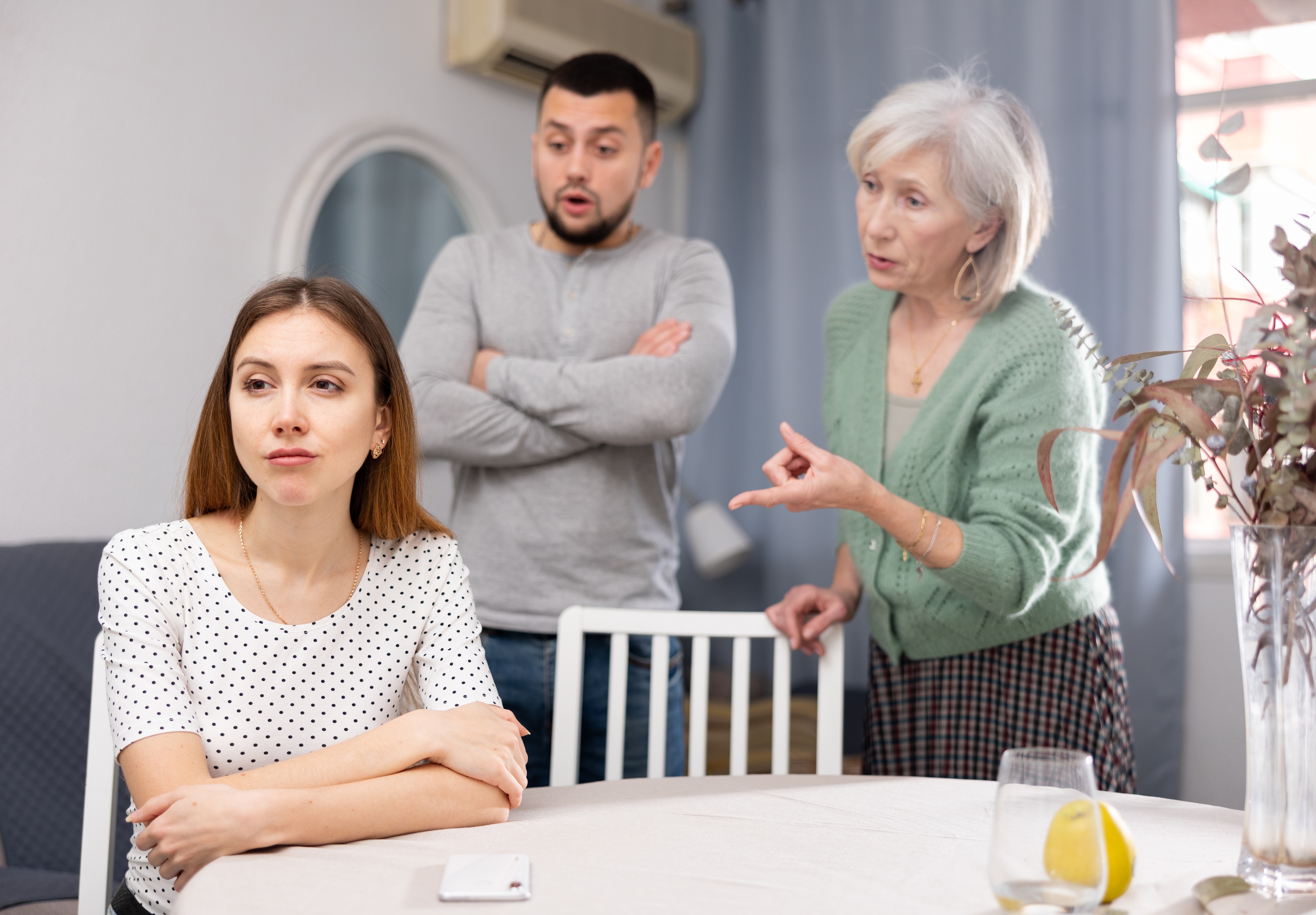 A woman emotional as her husband and his mother scold her | Source: Shutterstock