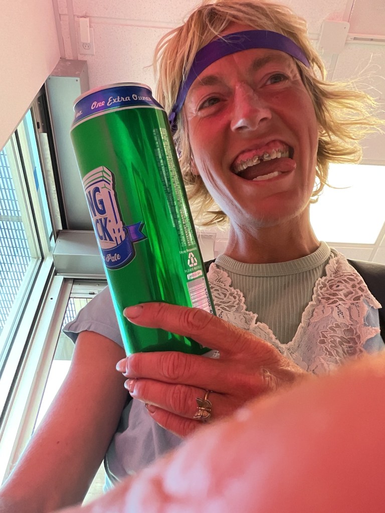 Kim Ann Andrews holding a Rolling Rock beer